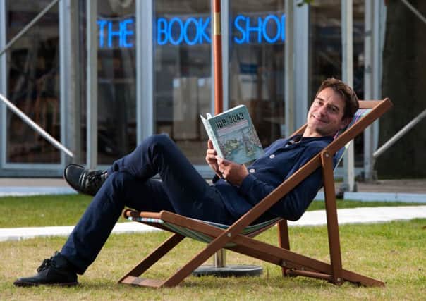 Edinburgh book festival director Nick Barley with a book the festival has commissioned imagining Scotland in 30 years time. Picture: Andrew OBrien