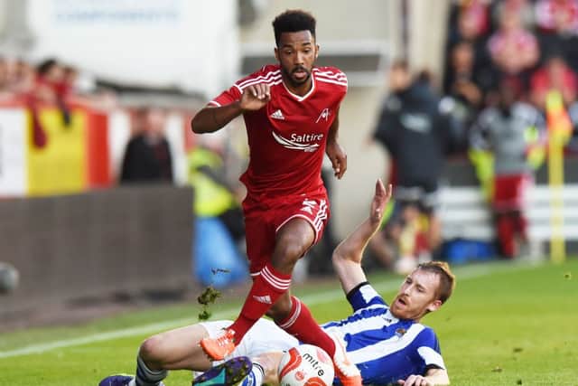 Aberdeen's Shaleum Logan (left) battles with David Zurutuza. Picture: SNS