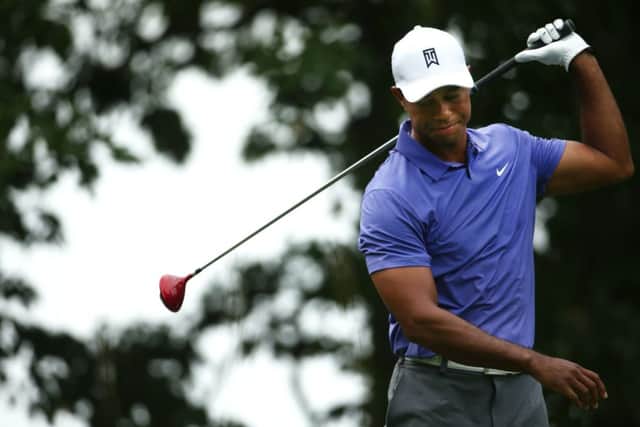 Tiger Woods shows his dismay as another drive goes astray at Valhalla, main; Woods parking spot lay empty during a practice round prior to the start of this years US PGA. Main photograph: Warren Little/Getty