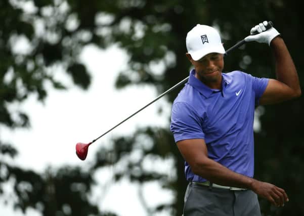 Tiger Woods shows his dismay as another drive goes astray at Valhalla, main; Woods parking spot lay empty during a practice round prior to the start of this years US PGA. Main photograph: Warren Little/Getty