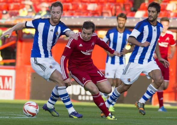 Aberdeen's Peter Pawlett (centre) and Real Sociedad's David Zurutuza (left). Picture: PA