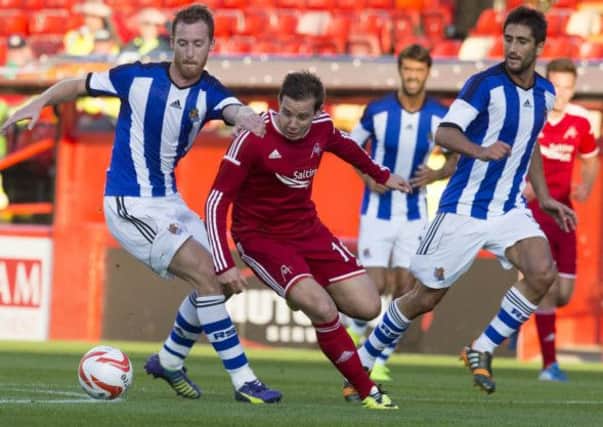 Aberdeen's Peter Pawlett (centre) and Real Sociedad's David Zurutuza (left). Picture: PA