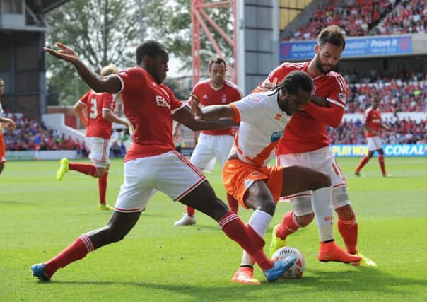 Michail Antonio and Danny Fox of Nottingham Forest combine to tackle Blackpools Nathan Delfouneso. Photograph: Getty Images