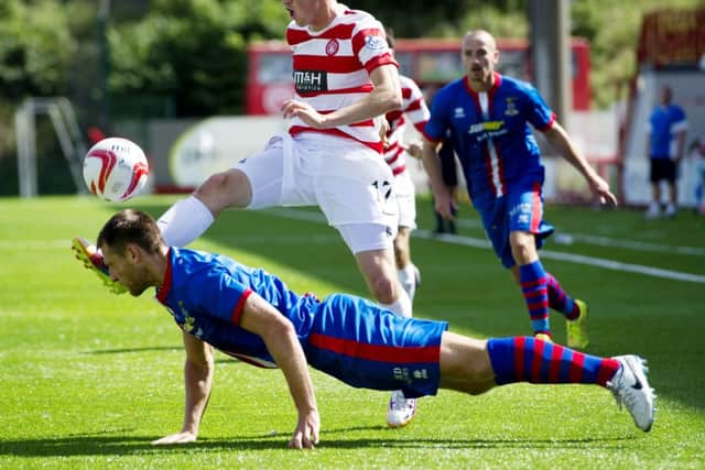 Gary Warren and Louis Longridge battle for possession. Picture: SNS