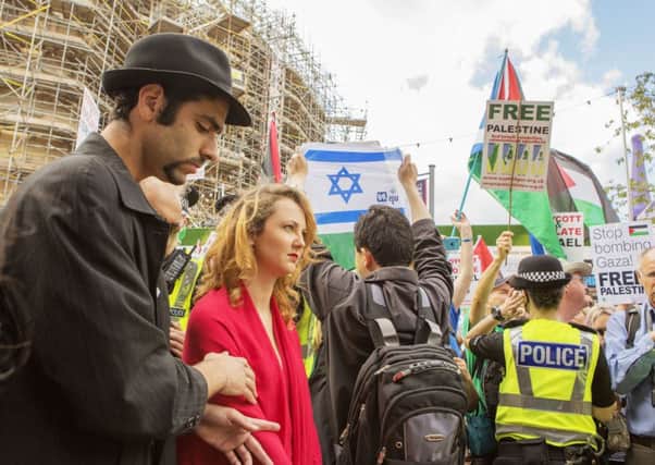 The Israeli actors perform in silence yesterday as pro-Palestinian activists chant and boo; below, a sit-in at Princes Street. Photographs: Malcolm McCurrach