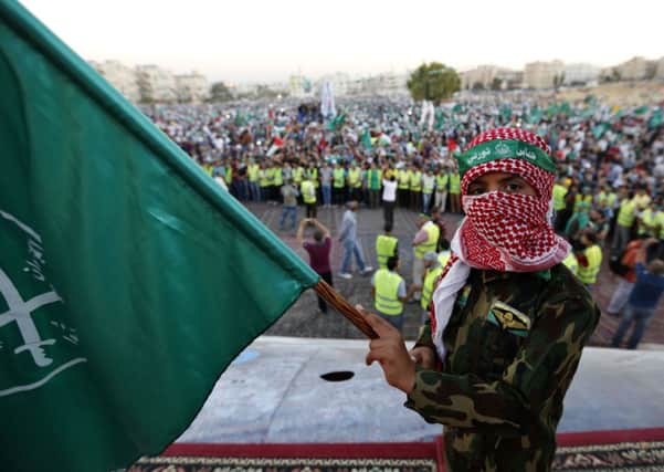 A boy holds a Muslim Brotherhood flag during a rally in support of Palestinians in Gaza in Jordan. Picture: Reuters