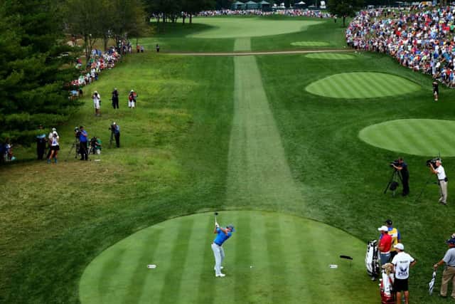 Playing to the gallery: Rory McIlroy tees off for yesterdays third round. The Open champion had taken the lead on Friday. Photograph: Jeff Gross/Getty