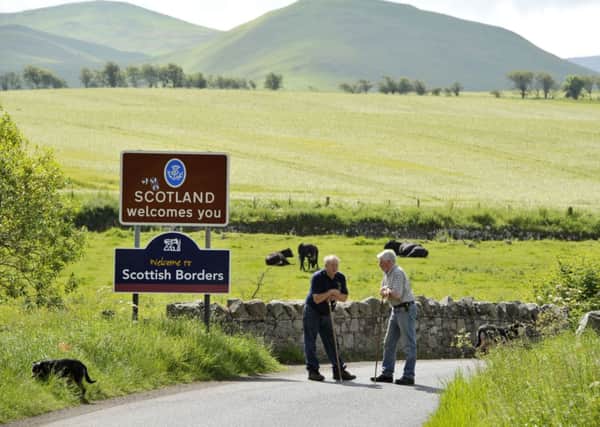 Simon Orpwood, seen right, who farms on the English side of the Border chats to his neighbour, James Playfair-Hannay, who farms just across the Border in Scotland. Picture: Ian Rutherford