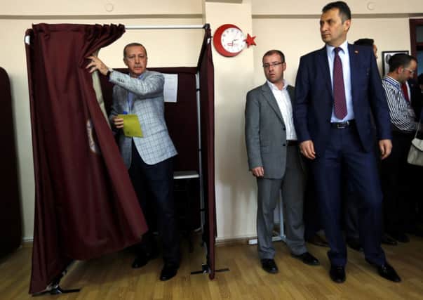 Prime Minister and presidential candidate Tayyip Erdogan leaves a polling booth to cast his ballot. Picture: Reuters