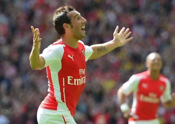 Arsenal's Spanish midfielder Santi Cazorla (L) celebrates scoring the opening goal during the FA Community Shield. Picture: Getty