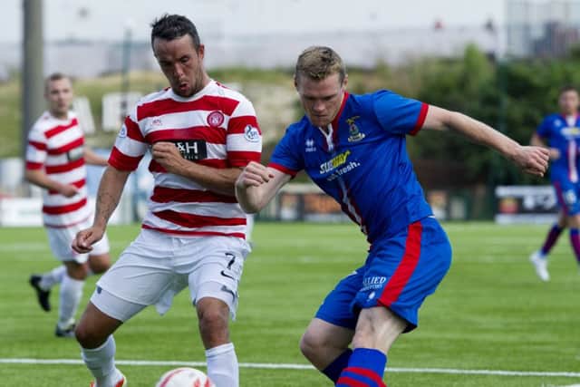 Inverness striker Billy McKay tries to deliver a cross under the close attention of Hamiltons Dougie Imrie  Picture: SNS