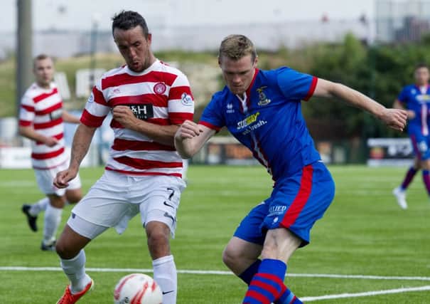 Inverness striker Billy McKay tries to deliver a cross under the close attention of Hamiltons Dougie Imrie  Picture: SNS