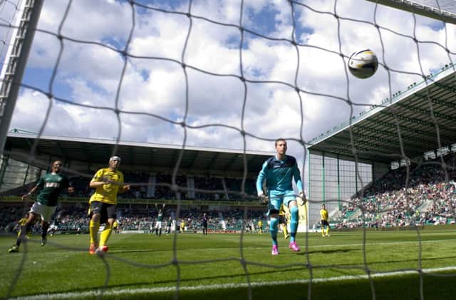 Livingston's Darren Jamieson (right) watches the ball bounce into the back of his net after a goal kick from Hibernian keeper Mark Oxley. Picture: SNS