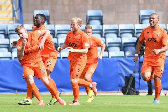 Craig Slater (left) is mobbed after pulling Kilmarnock level with a free-kick. Picture: SNS