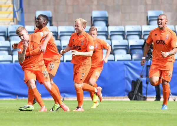 Craig Slater (left) is mobbed after pulling Kilmarnock level with a free-kick. Picture: SNS