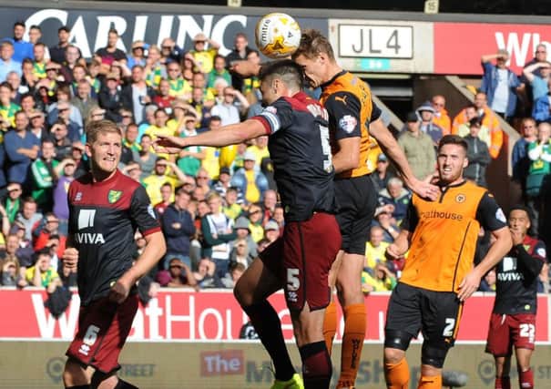 Wolves David Edwards rises above defender Russell Martin to nod home the only goal of the match at Molineux. Picture: Getty