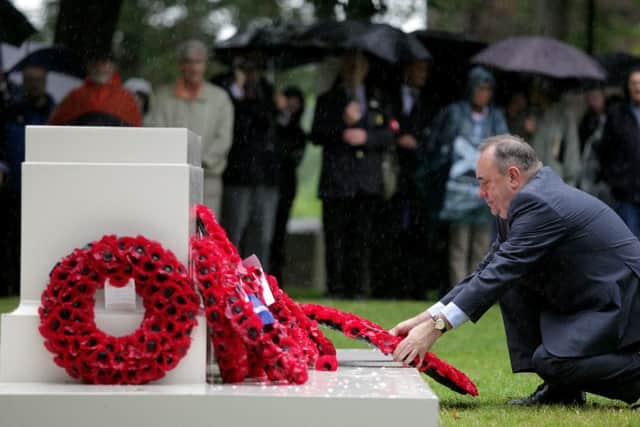 First Minister Alex Salmond lays a wreath at the temporary memorial in Holyrood Park. Picture: Hemedia
