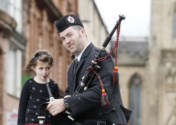 Andrew Douglas from the Stuart highlanders Pipe Band and five-year-old Grace Carruthers launch the Piping Live! Picture: PA