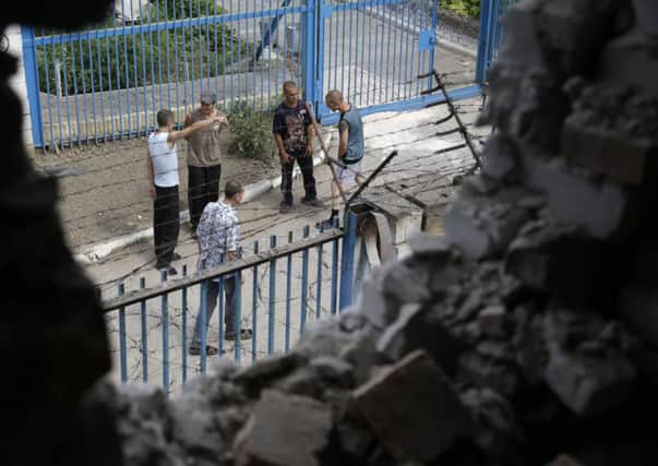 Prisoners are visible through a wall destroyed by shelling at a high-security facility in Donetsk, eastern Ukraine. Picture: AP