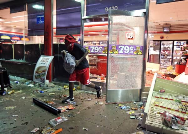 After a vigil for unarmed Michael Brown, 18, stores were looted by adults and children and a petrol station was burned down. Picture: AP
