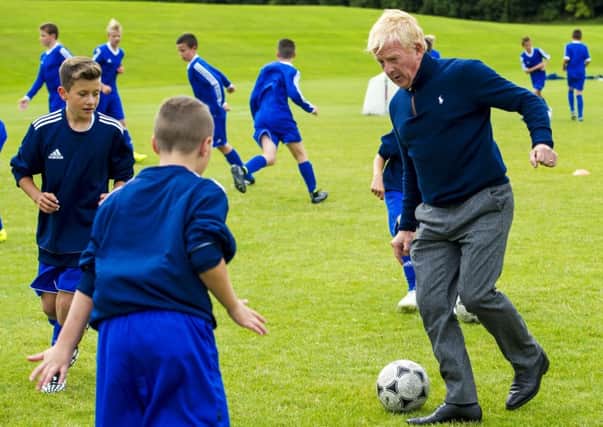 Gordon Strachan has a kickabout with kids at the site of the new National Performance Centre for Sport. Picture: SNS