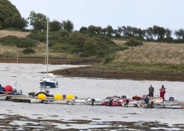 In the calm after the storm, boats are tied up on a yacht club pontoon. One sailor said crews were well-drilled and used to battling unfavourable conditions    Picture: PA