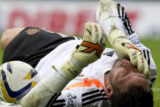 Hearts keeper Neil Alexander was left injured after a clash of heads with team mate Alim Ozturk. Picture: SNS