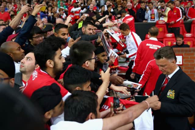 Manchester United manager Louis van Gaal signs autographs in the home dugout prior to last nights 2-1 win over ValenciaPicture: Getty Images
