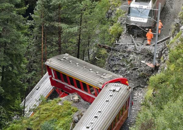 Rescuers work near a train after it was derailed by a landslide near Tiefencastel, in a mountainous part of eastern Switzerland. Picture: Getty