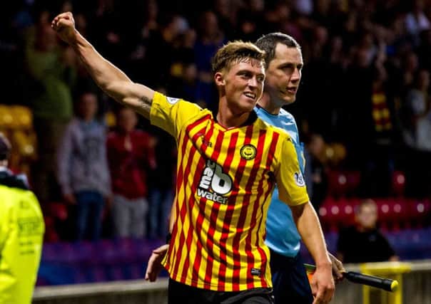 Gary Fraser celebrates his strike as Partick go three goals up. Picture: SNS