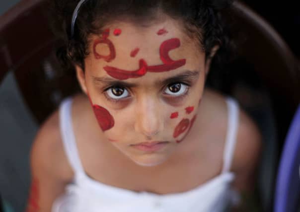 A young Palestinian girl, a guest at a Gaza wedding, shelters in Al-Shati refugee camp as Israel bombards the area. Picture: Anadolu Agency