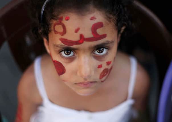 A young Palestinian girl, a guest at a Gaza wedding, shelters in Al-Shati refugee camp as Israel bombards the area. Picture: Anadolu Agency