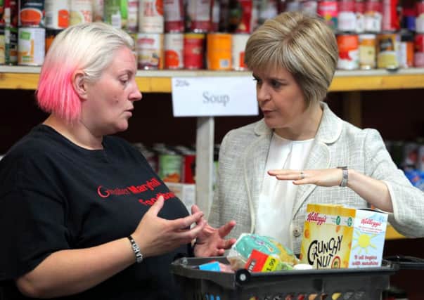 Julie Webster, from the Greater Maryhill Foodbank, encounters Nicola Sturgeon.Picture: Hemedia