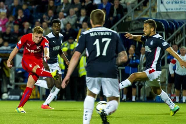 Rangers' Lewis MacLeod (left) puts his side ahead after his shot deflects off a Falkirk defender and ends up in the back of the net. Picture: SNS