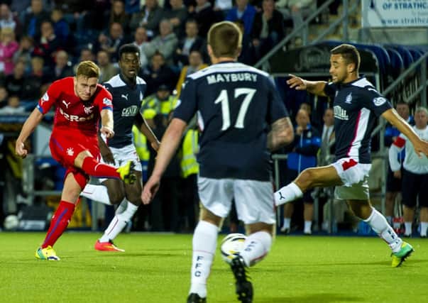Rangers' Lewis MacLeod (left) puts his side ahead after his shot deflects off a Falkirk defender and ends up in the back of the net. Picture: SNS