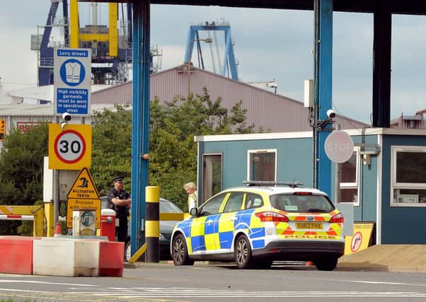 A police car arrives at the entrance to Tilbury Docks in Essex. Picture: PA
