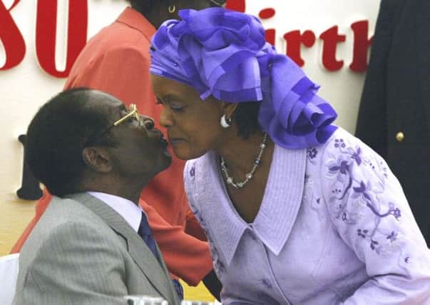 Robert Mugabe, 90, kisses his wife Grace, 49, who has a seat on Zanu-PFs top decision-making body. Photograph: AP