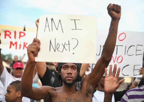 Demetrus Washington joins other demonstrators protesting the shooting death of teenager Michael Brown. Picture: Getty