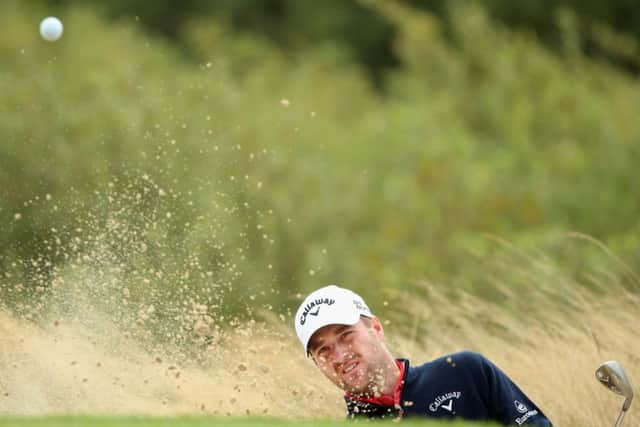 Marc Warren plays a bunker shot on the fourth hole during the third round of the Made In Denmark at Himmerland in Aalborg, Denmark. Photograph: Andrew Redington/Getty