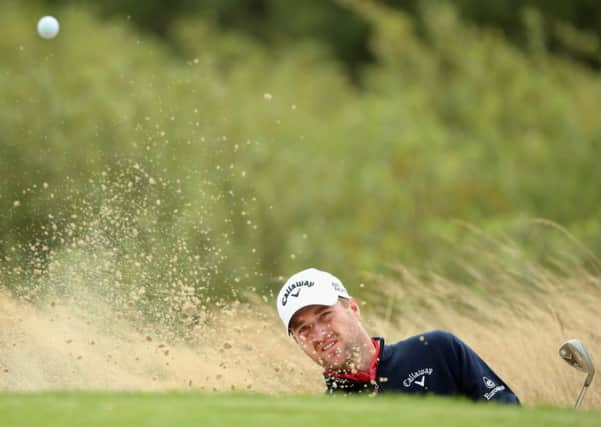 Marc Warren plays a bunker shot on the fourth hole during the third round of the Made In Denmark at Himmerland in Aalborg, Denmark. Photograph: Andrew Redington/Getty