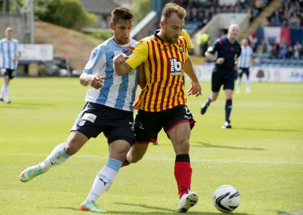 Partick Thistle's Conrad Balatoni holds off Dundee's Luka Tankulic. Picture: Kenny Smith