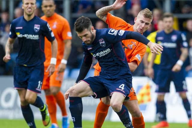 Kilmarnock's Craig Slater challenges Ross County's Rocco Quinn. Picture: Craig Foy