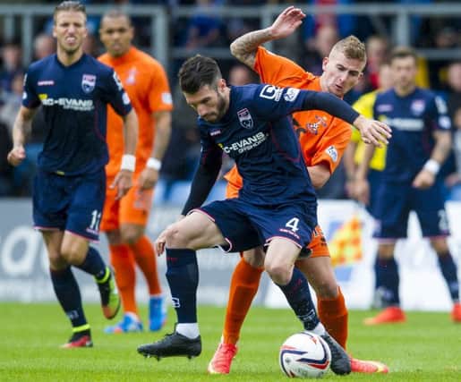 Kilmarnock's Craig Slater challenges Ross County's Rocco Quinn. Picture: Craig Foy