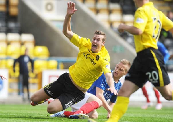 Livingston striker Jordan White attracts the attentions of Thomas OBrien yesterday. Photograph: Neil Hanna Photography