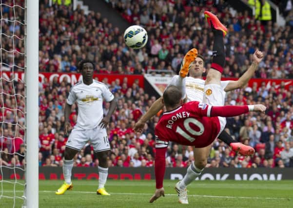 Wayne Rooney, bottom right, equalises against Swansea City at Old Trafford yesterday. Photograph: Jon Super/AP Photo