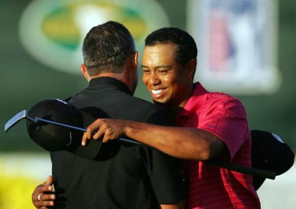 Tiger Woods hugs his caddie after winning the World Golf Championship CA Championship at Miami in 2006. Picture: Getty