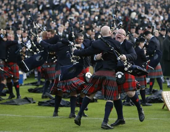 Members of the Field Marshall Montgomery Pipe Band from Northern Ireland celebrate collecting the ultimate accolade. Picture: Reuters