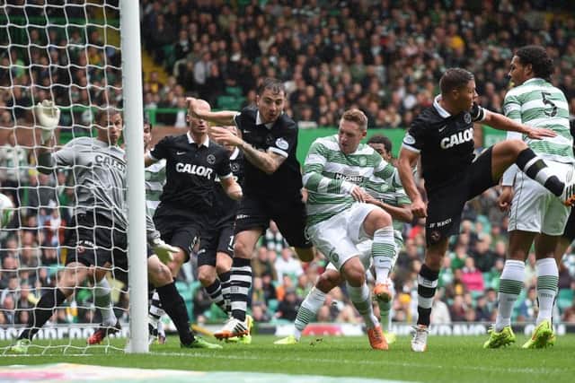 Kris Commons finds a tiny amount of space in the box to make it 2-0 to Celtic. Picture: SNS