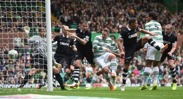 Kris Commons finds a tiny amount of space in the box to make it 2-0 to Celtic. Picture: SNS