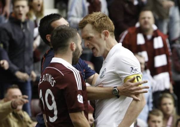 Referee Willie Collum steps in as temperatures rise at Tynecastle. Picture: Toby Williams